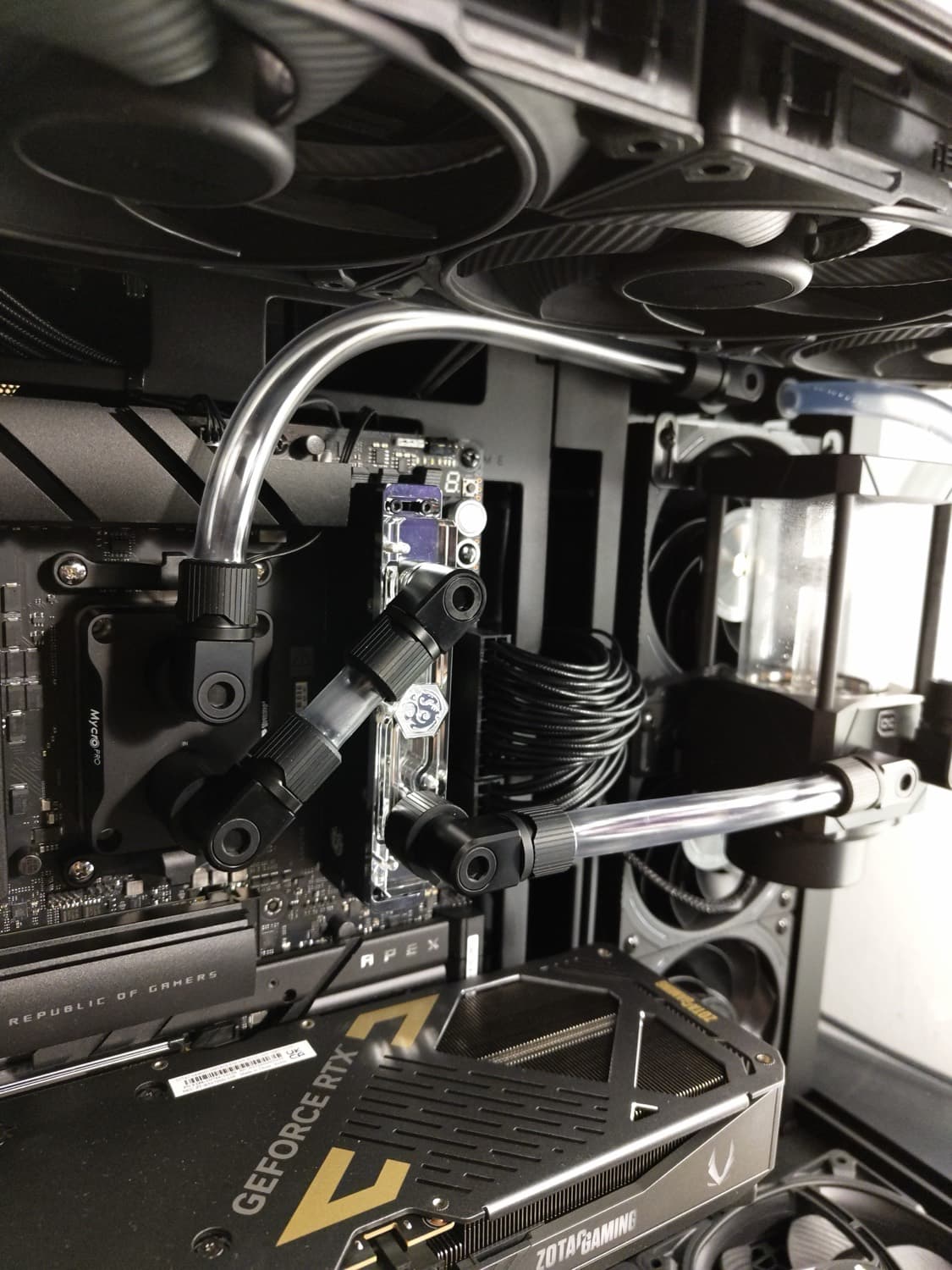 Delidded CPU with direct-die block and EK Quantum Torque fittings, daylight